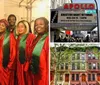 A group of people are smiling for the camera wearing matching red and green choir robes