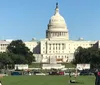 The image shows people enjoying a sunny day on the grass with the United States Capitol building in the background