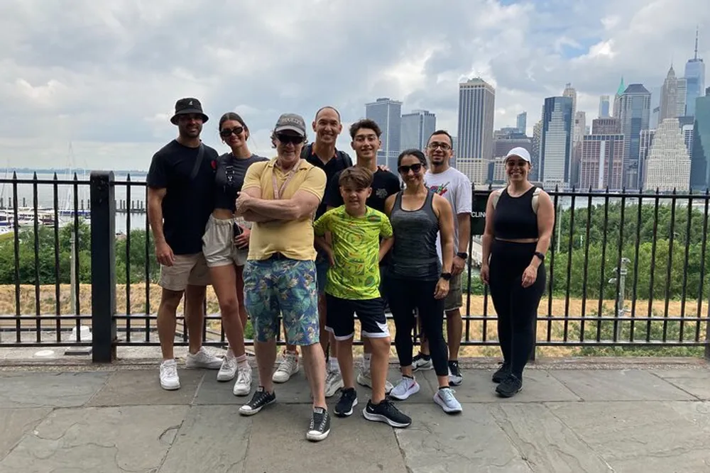 A group of people posing for a photo with a scenic city skyline in the background