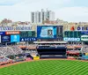 The image shows the exterior of Yankee Stadium a prominent baseball park on a sunny day with clear blue skies