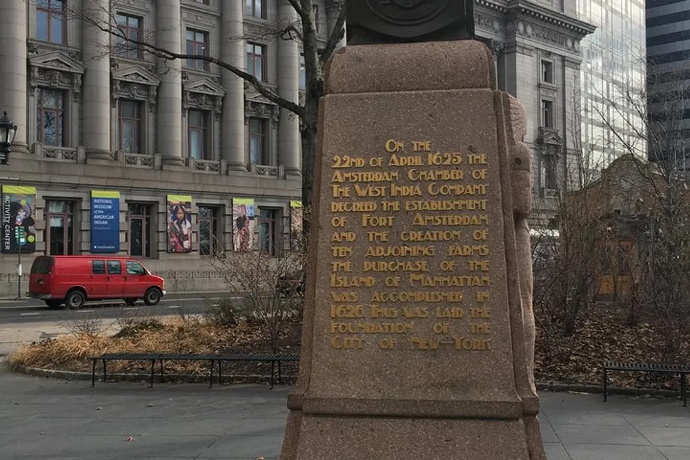 The image shows an informational plaque commemorating the establishment of Fort Amsterdam and the purchase of Manhattan Island in 1626 which laid the foundation for New York City set against a backdrop of city buildings and a red van
