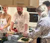A group of people is actively engaged in a cooking class or workshop preparing various ingredients on a kitchen counter