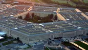 The image shows an aerial view of the Pentagon, the headquarters of the United States Department of Defense, captured during twilight hours.