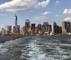 Two people are conversing on a ferry with the New York City skyline in the background