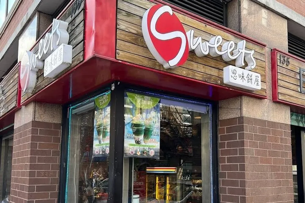 The image shows the storefront of a dessert shop named Sweets with signage in English and Chinese displaying an advertisement for matcha-flavored refreshments in the window