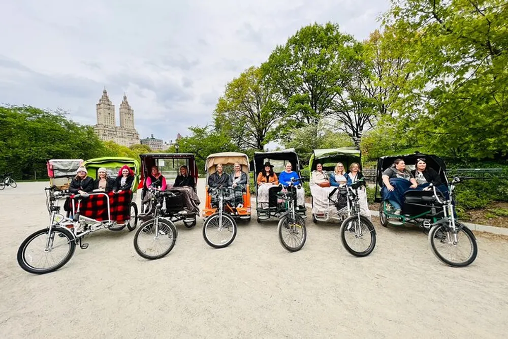 The image features three pedicabs with passengers in a park-like setting possibly on a city tour with greenery and buildings in the background