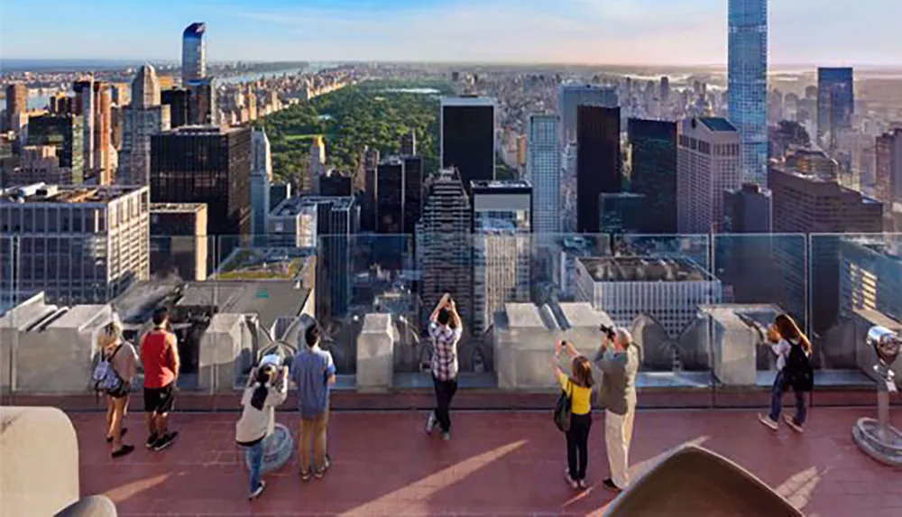 Visitors enjoy panoramic views of a cityscape from a high vantage point taking photos and observing the skyline