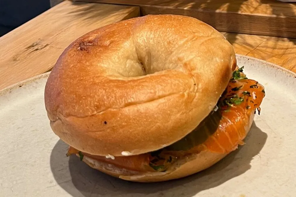 A bagel with smoked salmon and cream cheese served on a plate