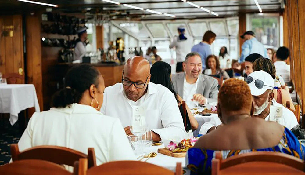 The image shows a lively dining scene aboard a cruise with guests enjoying their meals and conversation