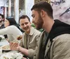 A group of people are enjoying a meal together at a restaurant with Chinese-style decor