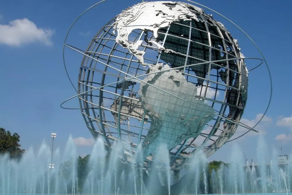 The image shows the Unisphere a spherical stainless steel representation of the Earth surrounded by fountain sprays and located at Flushing MeadowsCorona Park in Queens New York