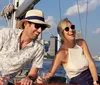 A group of people wearing Statue of Liberty crowns are smiling for a photo with the actual Statue of Liberty in the background likely enjoying a boat tour