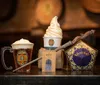 The image features an assortment of Harry Potter-themed items including a butterbeer in a mug with whipped cream on top a soft-serve ice cream cone a chocolate frog package a wand and a brown paper bag with a logo all set against the backdrop of barrels