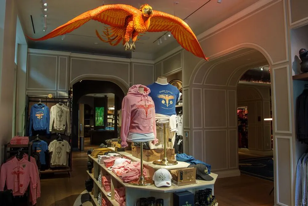 A life-sized model of a bright orange phoenix hangs above merchandise displays in a themed retail store