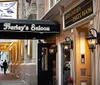The image shows the exterior of Hurleys Saloon featuring its entrance and signage with a pedestrian walking by on the sidewalk