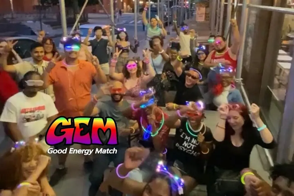 A group of people appear to be enjoying a social event at night wearing glowing headbands and accessories with a logo and text GEM - Good Energy Match superimposed onto the image