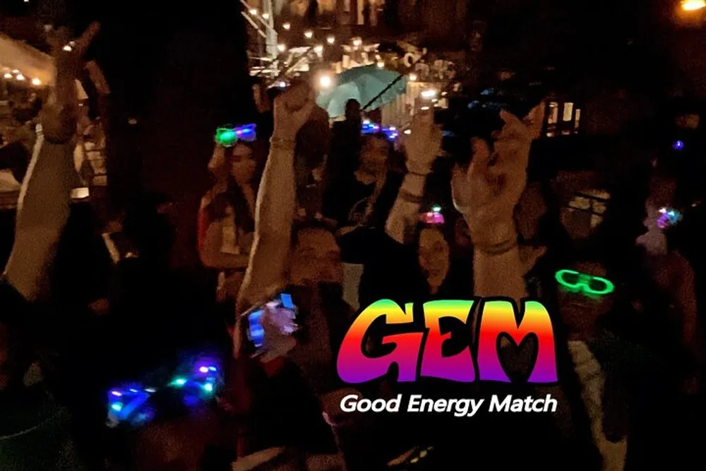 A group of people are gathered in a dark setting some wearing glowing accessories with the words GEM Good Energy Match superimposed on the image