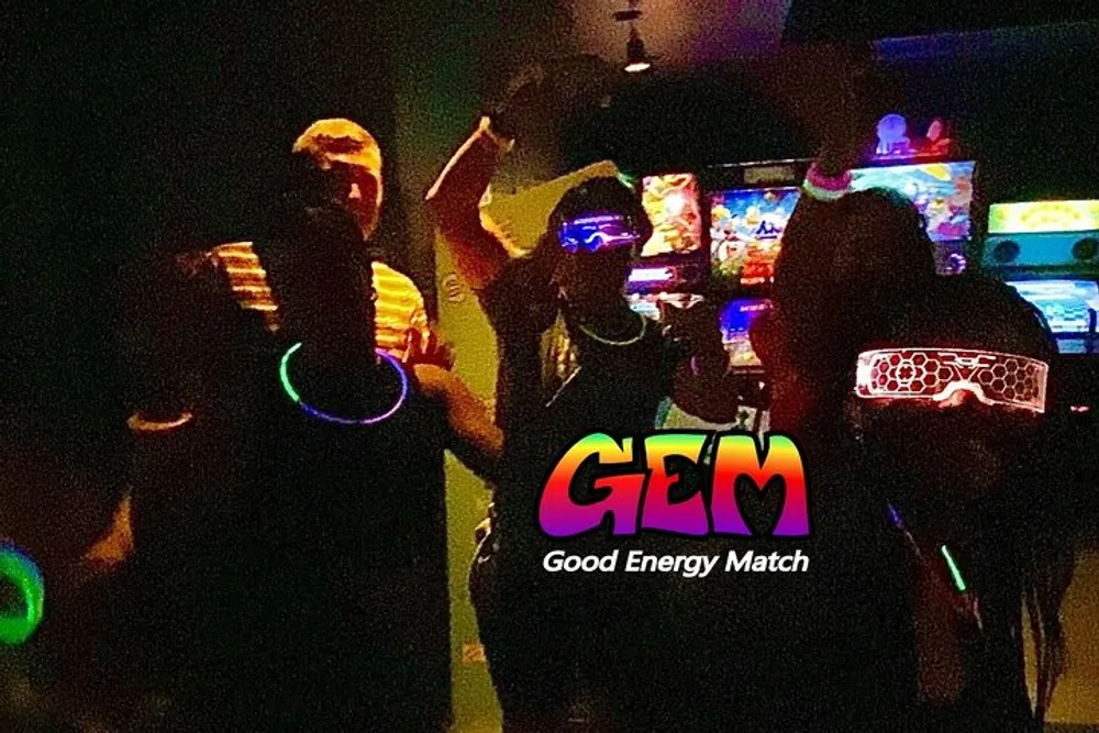 A group of people wearing glowing accessories appears to be having a good time at a dimly-lit party or event marked by a logo that reads GEM Good Energy Match at the bottom