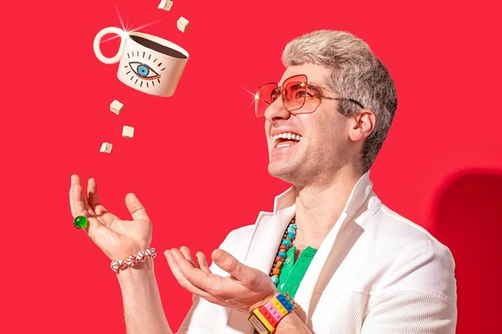 A joyful person juggling sugar cubes and a coffee cup decorated with an eye motif set against a vibrant red background