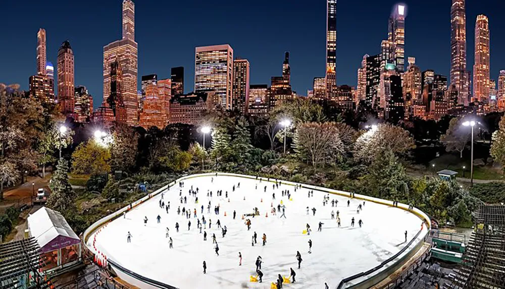 An outdoor ice skating rink bustles with skaters in the evening set against a backdrop of the illuminated skyscrapers of a city