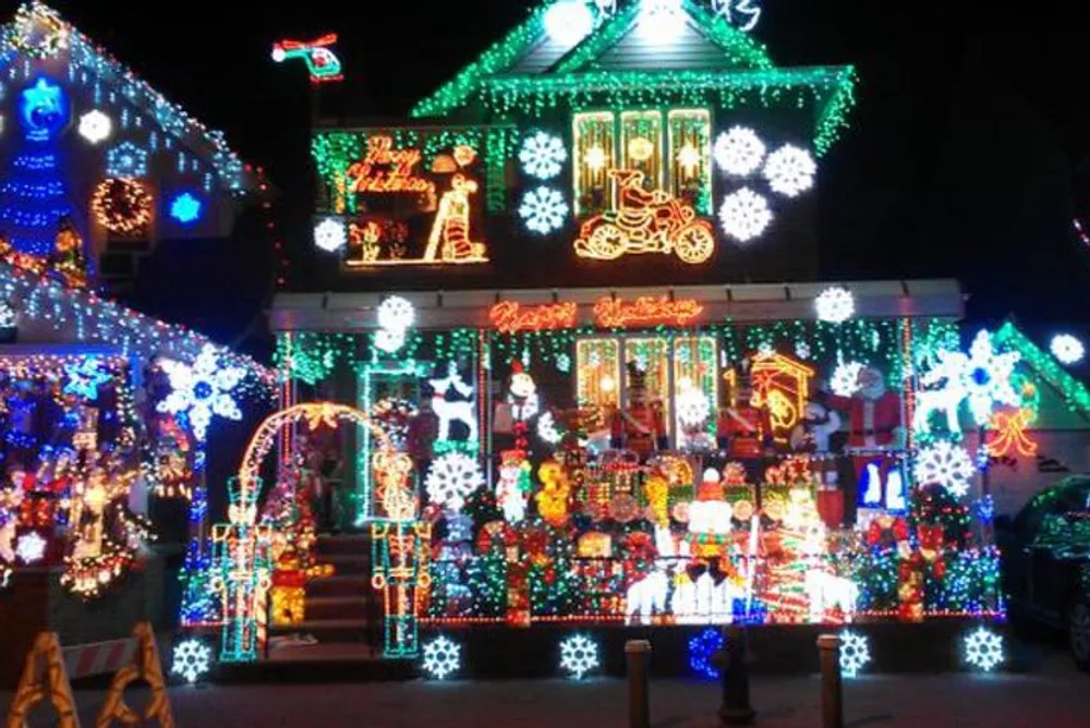 A house is extravagantly decorated with a variety of colorful Christmas lights and festive displays creating a bright and elaborate holiday spectacle