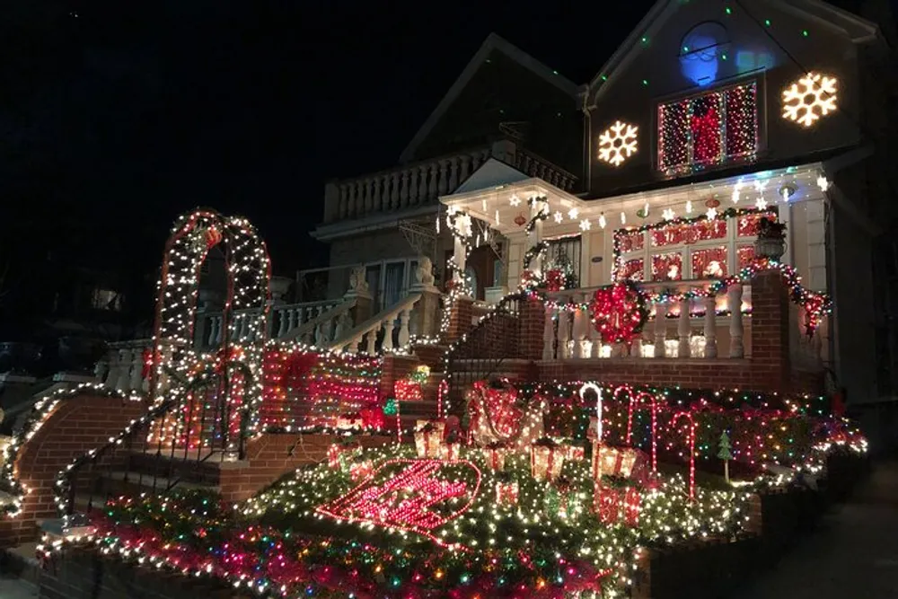 A house is adorned with an elaborate display of colorful Christmas lights and decorations in the evening