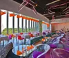 The image shows a modern restaurant interior with vibrant colors contemporary furnishings and large windows that offer plenty of natural light