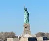 The image showcases the Statue of Liberty against a clear blue sky symbolizing freedom and democracy