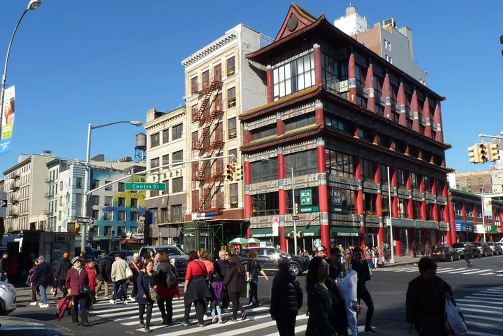 The image shows a bustling urban street corner with pedestrians featuring a distinctive building with red accents and a Chinese architectural style