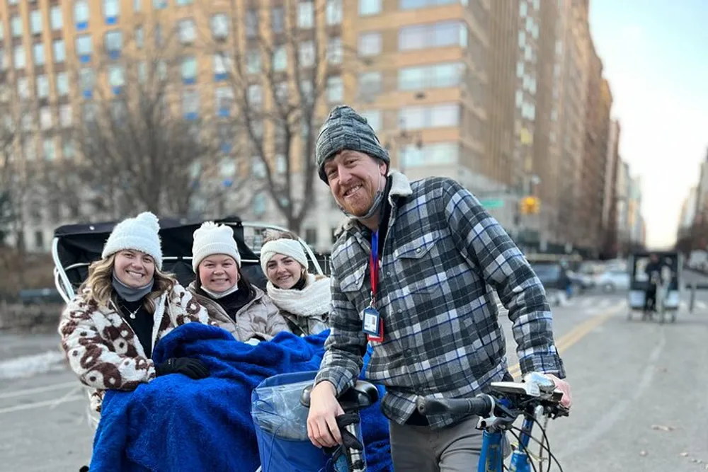 A group of smiling people are enjoying a pedicab ride on a city street during a chilly day