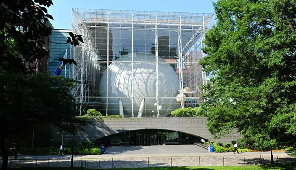 The image shows the Rose Center for Earth and Space a part of the American Museum of Natural History with its distinctive glass cube enclosing the Hayden Sphere