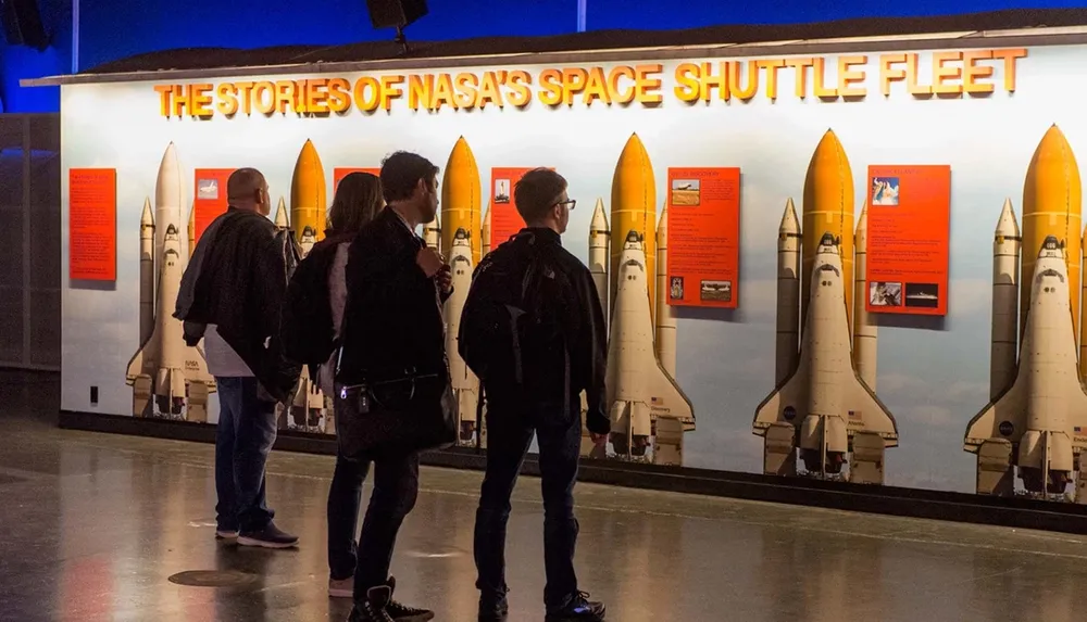 Visitors are viewing an exhibit featuring the stories of NASAs Space Shuttle fleet