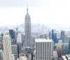 Visitors are enjoying an aerial view of a dense urban skyline from a high observation deck