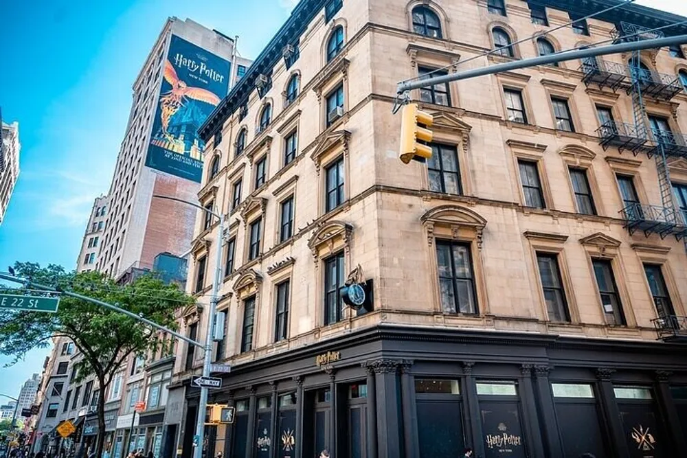 The image shows a street corner in an urban setting with historical buildings clear blue skies and a prominent Harry Potter advertisement on a building in the background