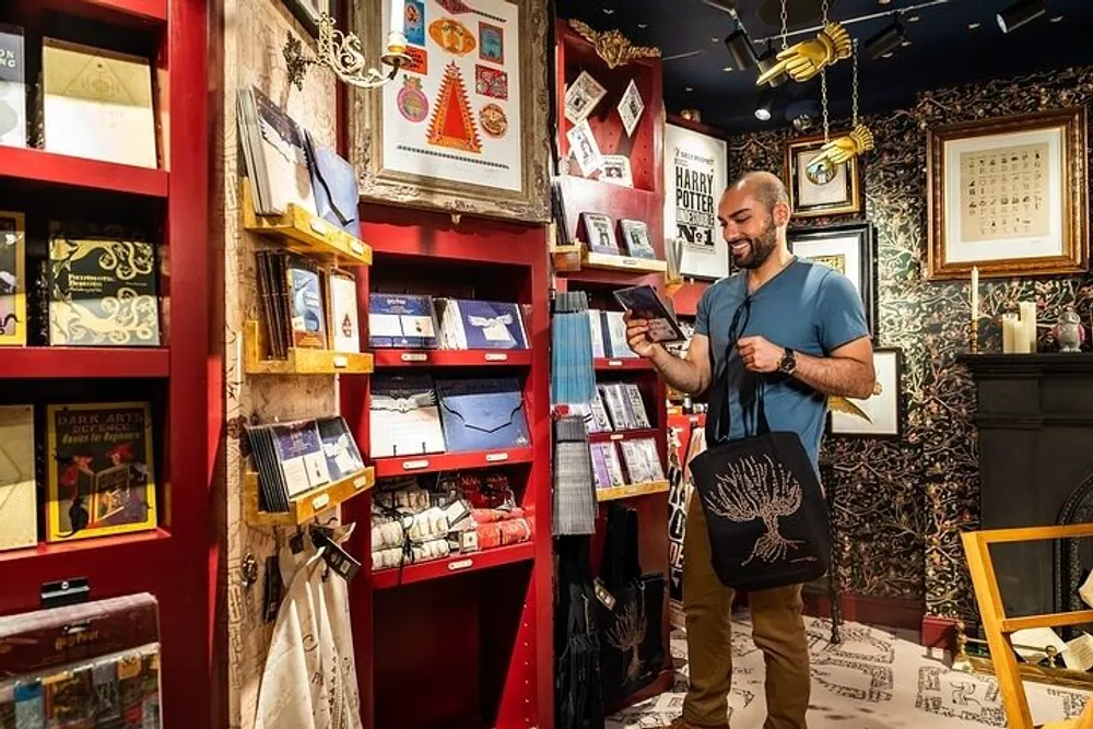 A smiling person is browsing through a Harry Potter-themed shop filled with memorabilia and merchandise