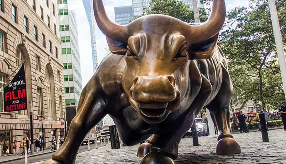 The image shows the iconic Charging Bull statue a symbol of financial optimism and prosperity located in the Financial District of Manhattan New York City