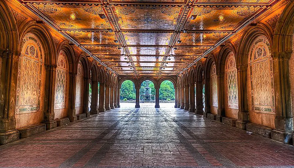 This image showcases an ornate covered walkway with intricate arches and a decorative ceiling inviting light at the far end