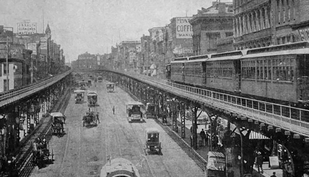 The image is a black and white photograph showing an elevated train line running above a busy street with horse-drawn carriages and pedestrians from what appears to be the late 19th or early 20th century