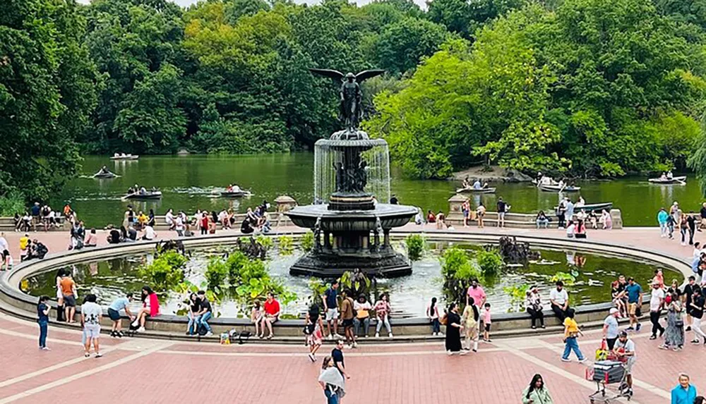 The image captures a vibrant outdoor scene with people enjoying leisure activities around a central fountain and on rowboats in a lush park setting