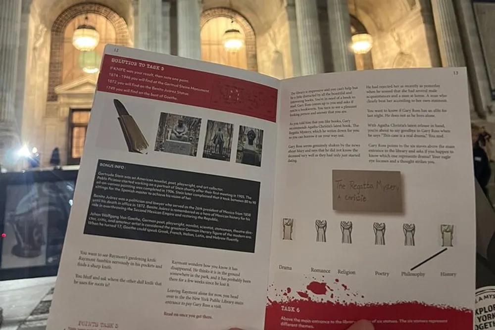 The picture shows an open brochure or booklet with printed text and images held up against a blurred background of a grand architectural interior possibly a library or a museum