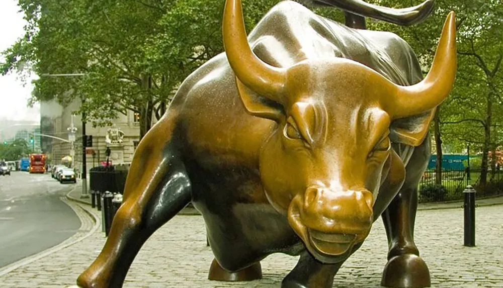 The image features the Charging Bull sculpture a famous bronze statue that symbolizes Wall Street and the financial optimism and prosperity located in New York City