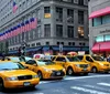 The image shows a bustling Times Square in New York City characterized by its vibrant electronic billboards dense traffic and crowds of pedestrians