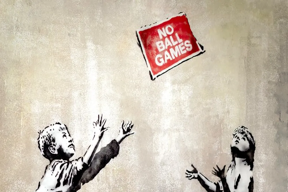 Two stencil-style children appear to be throwing a sign that says NO BALL GAMES like a ball on a textured wall background