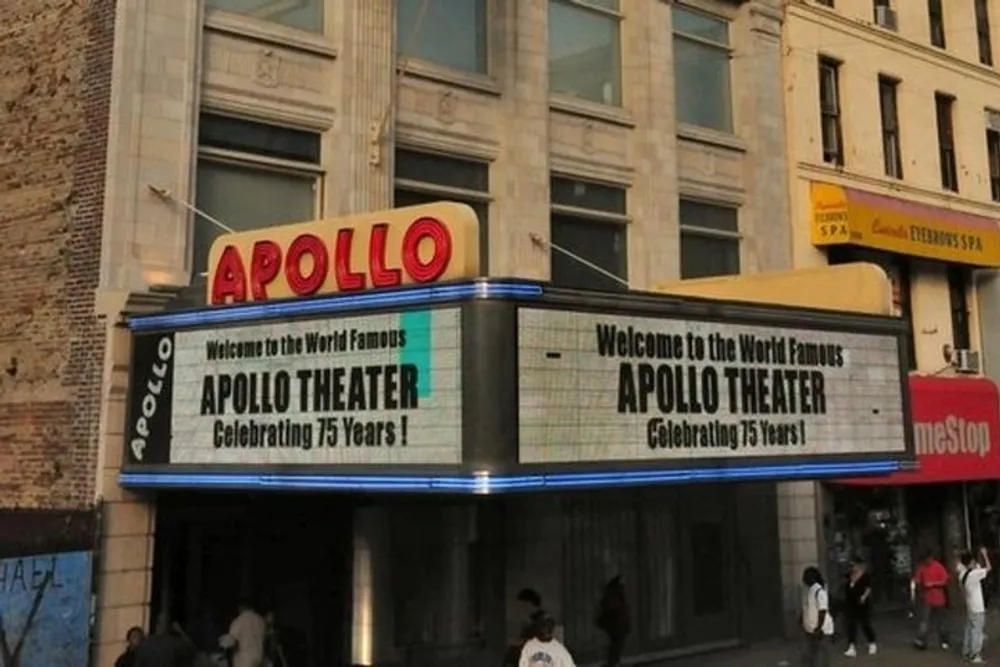 The image shows the iconic Apollo Theater marquee celebrating its 75th anniversary set in an urban street scene with pedestrians