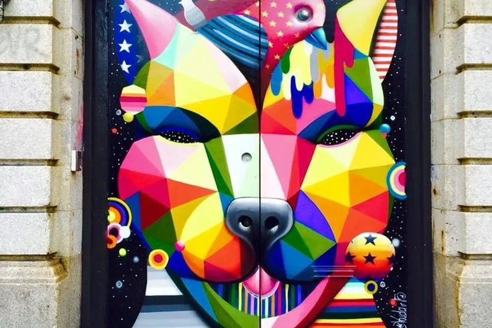 The image shows a vibrant multicolored mural of an abstract dog painted on a door featuring a mix of geometric shapes and vivid patterns