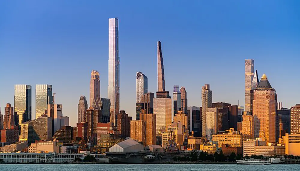 The image shows a skyline view of modern skyscrapers bathed in the golden light of a setting or rising sun taken from across a body of water