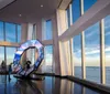 A couple is enjoying a scenic view of a cityscape from a high vantage point with large windows