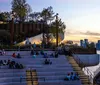 Visitors enjoy a panoramic view of a city skyline from a high vantage point with protective glass barriers