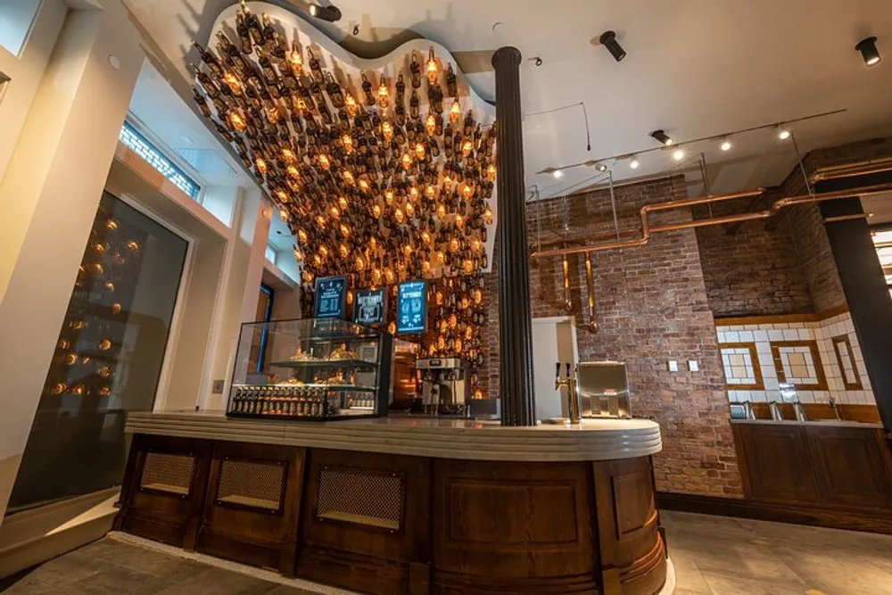 The image features an elegant bar with a distinctive overhead design comprised of numerous hanging light bulbs creating a warm and inviting atmosphere