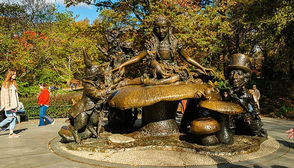 This image shows a whimsical bronze statue depicting characters from a classic story surrounded by park-goers enjoying a sunny day